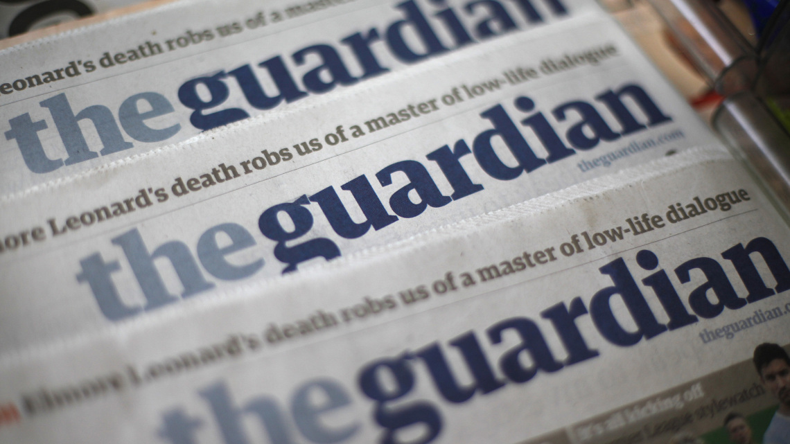 Copies of the Guardian newspaper are displayed at a news agent in London