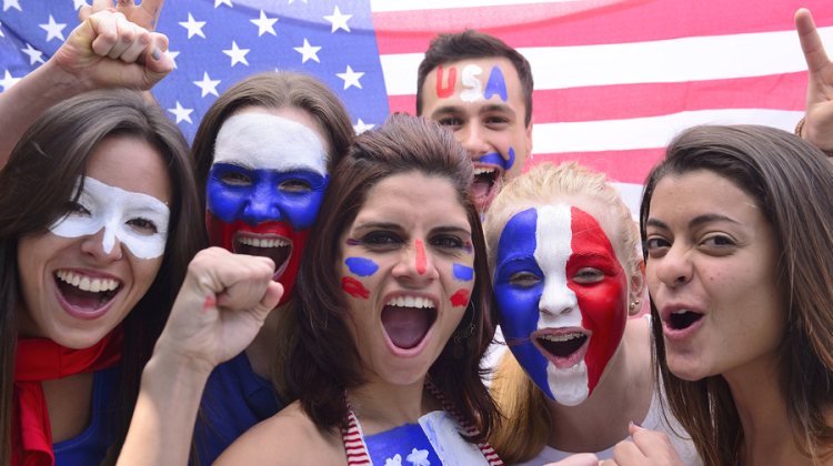 Group of happy USA soccer fans commemorating victory yelling.