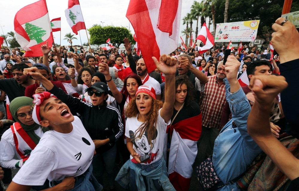 Demonstrators gesture and chant slogans during an anti-government protest in the southern city of Tyre