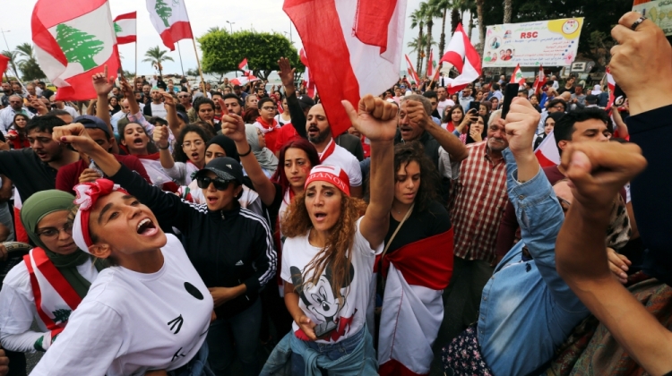Demonstrators gesture and chant slogans during an anti-government protest in the southern city of Tyre